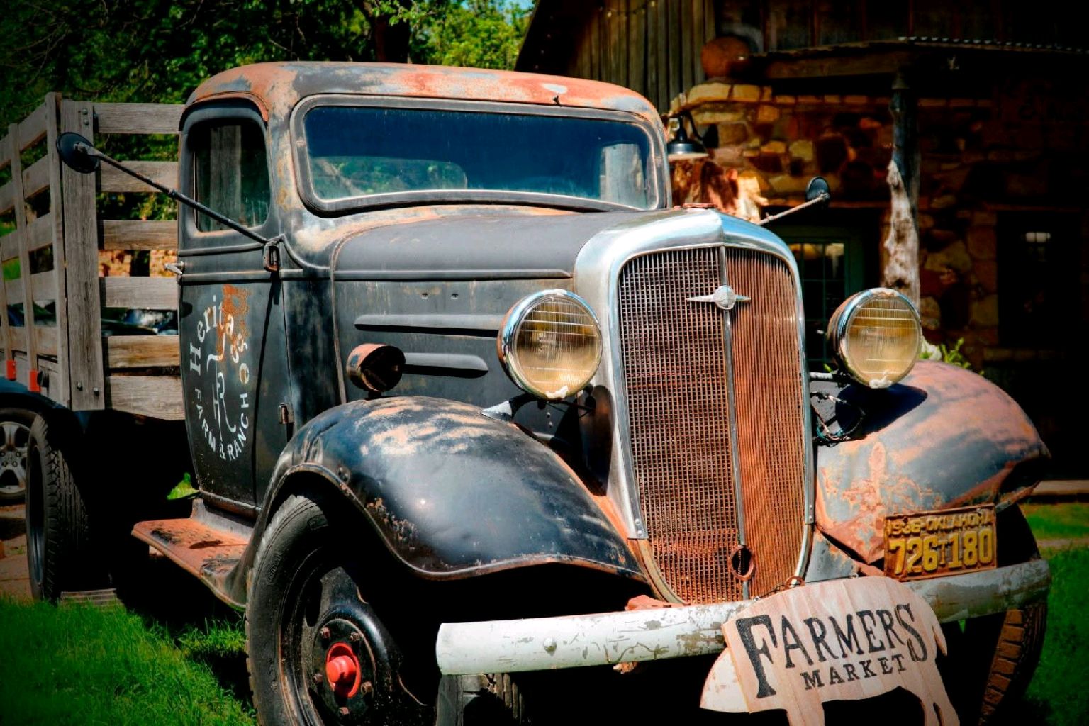 Antique farm truck parked beside a rustic Oklahoma building